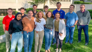 A group of 2023 summer interns pose for a photo outside of the Crete Carrier headquarters in Lincoln, Nebraska