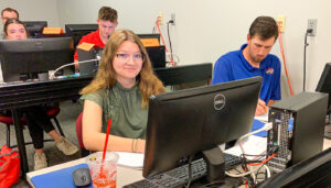 A couple of 2023 interns go through on-site training of the Operations software as part of their summer internship at Crete Carrier