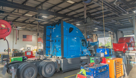 A red and blue truck undergo maintenance and repair at the shop in Columbus, Ohio