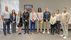 A group of interns from the 2025 Crete Carrier Internship Class pose for a photo after delivering their logistics presentations.